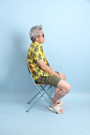 HAPPY SONGKRAN DAY. Asian tourist senior man in summer clothing with gesture of  sitting isolated on...