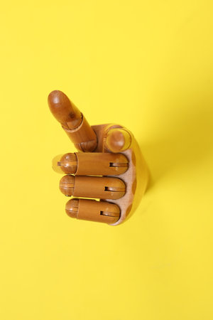 Hand of mannequin with multiple poses isolated on yellow background. Symbol, Puppet.の写真素材