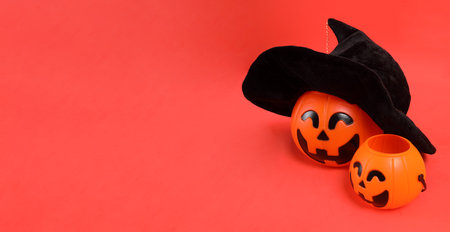 HAPPY HALLOWEEN DAY, Jack-o-Lantern Pumpkin wearing witch hat or wizard hat isolated on orange background.の写真素材