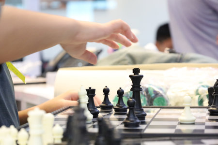Group of friends playing chess during tournament in class. Board game, Youth, hand, Gen Z, entertainment, hobby and education conceptの写真素材