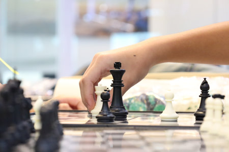 Group of friends playing chess during tournament in class. Board game, Youth, hand, Gen Z, entertainment, hobby and education conceptの写真素材