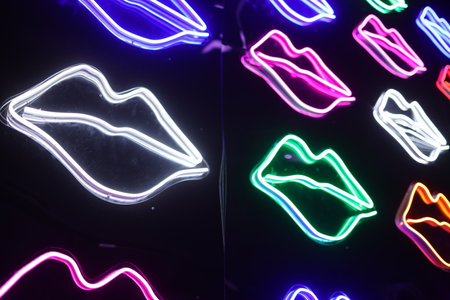 Colorful Neon Light Lip Shape or kiss Background. Multicolored icons. Abstract Valentine's Day Concept. Feminine.の写真素材