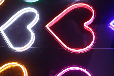Colorful Neon Light Heart Shape Background. Multicolored icons. Abstract Valentine's Day Conceptの写真素材