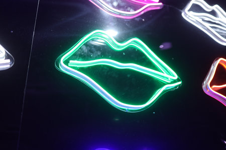 Colorful Neon Light Lip Shape or kiss Background. Multicolored icons. Abstract Valentine's Day Concept. Feminine.の写真素材