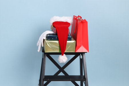 Christmas, new year holiday present boxes, gifts pile with bright wrapping, silk ribbon bows on blue background.の写真素材