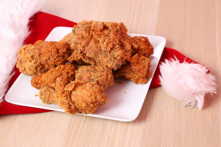 Japanese Christmas Table with a small decorated a white plate of crispy fried chicken, onÂ a wooden table. Kentucky, Thanksgivingの写真素材