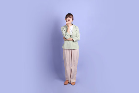 A young asian Businesswoman in formal outfit with gesture of thinking isolated on purple background. Gen Z, internship, Career, Officeの写真素材