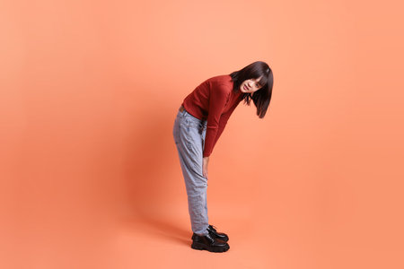 Short hair asian woman in red casual long sleeve t-shirt with gesture of Standing and smiling...