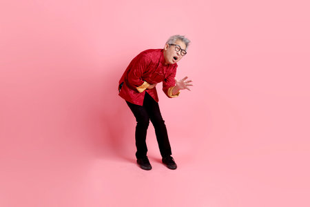 Happy Chinese new year. Asian Chinese senior man wearing red traditional cheongsam qipao or...