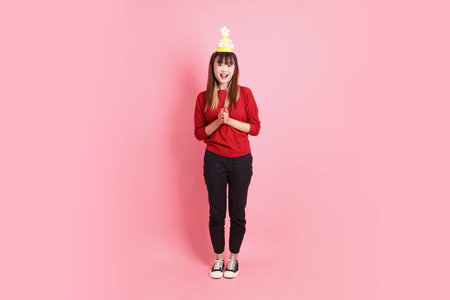 young female asian woman in red casual t-shirt with gesture of surprise isolated on pink background. Gen Z, wow and impressiveの写真素材