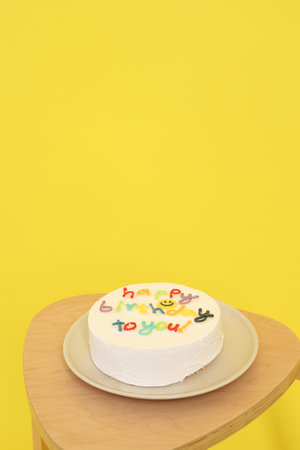 Birthday Cake with  Happy Birthday text isolated on yellow background, Happy Birthday Concept. Family, Party hat , Gift boxの写真素材