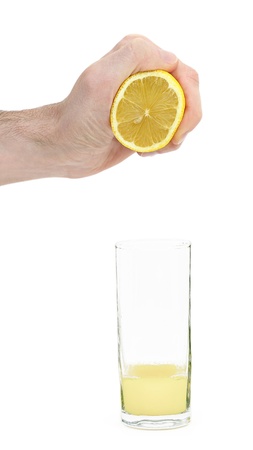 Squeeze the lemon juice into the glass by handの写真素材