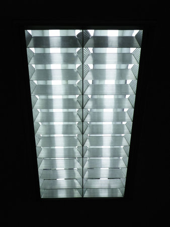 symmetrical photo of neon lights on the office ceiling