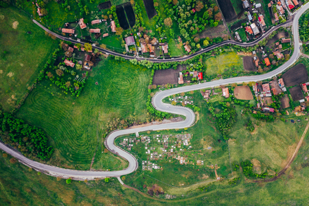 Curvy road from a drone view and agriculture fieldsの写真素材