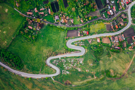 Curvy road from a drone view and agriculture fieldsの写真素材