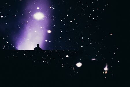 Stage lights and crowd of audience with hands raised at a music festival. Fans enjoying the party vibes.の写真素材