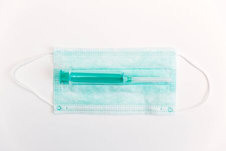 Surgical mask, syringe and stethoscope on white background. 2019-ncov concept.の写真素材