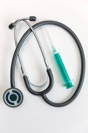Surgical mask, syringe and stethoscope on white background. 2019-ncov concept.の写真素材