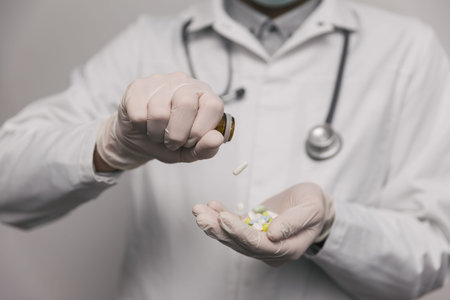 Close-up of male doctor giving too much pills.  Overdose concept.の写真素材