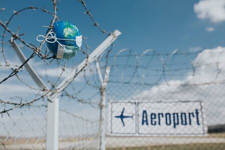 Surgical mask on Earth globe. Epidemics concept. World infected with Covid-19 / Coronavirus.の写真素材