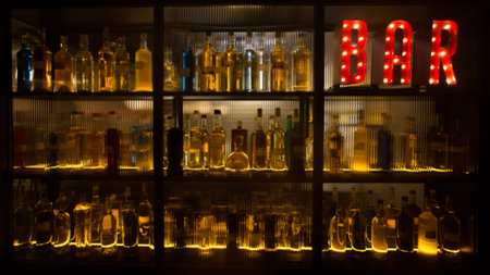 BAR sign with lights in the dark with many shapes of bottles of alcohol.