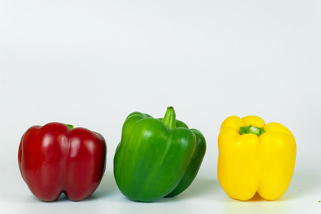 Bell pepper isolated on white background. Red, yellow and green peppers.の写真素材