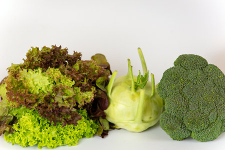 Vegetables on a white background. Green salad, red cabbage, broccoli.の写真素材