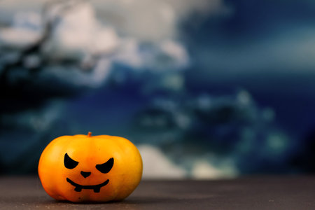 Halloween pumpkin with scary face on dark sky background. Halloween conceptの写真素材
