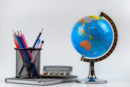 Globe, calculator and pencils on white background. Back to school concept.の写真素材