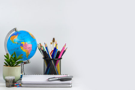 Back to school concept. School supplies and globe on white background.の写真素材