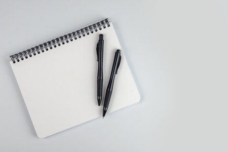 Notebook and pen on the white background with space for text.の写真素材