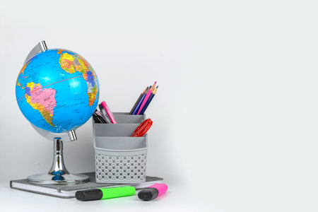 School supplies and globe on white background. Back to school concept.の写真素材