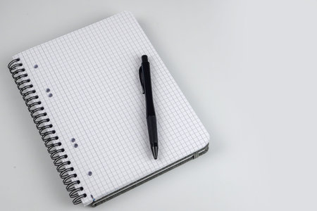 Notebook and pen on a white background. View from above.