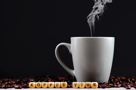 Coffee beans with a cup of coffee on a black backgroundの写真素材