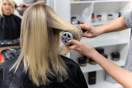 Professional hairdresser working with client in salon, closeupの写真素材