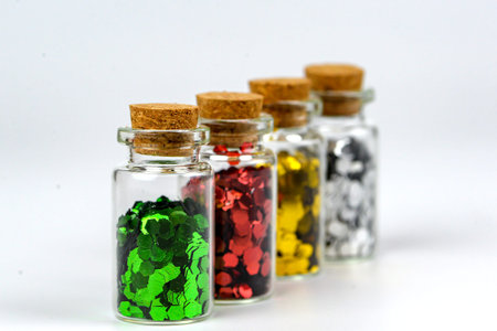 Colorful glass bottles isolated on white background. Selective focus.