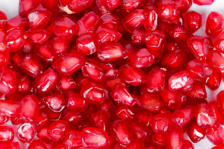 pomegranate seeds on a white background close-up macroの写真素材