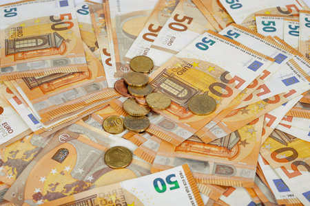 Euro banknotes and coins as a background, close-up.