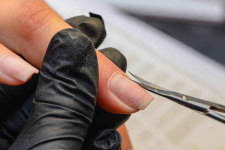 Close-up manicure process, female hands painting nailsの写真素材