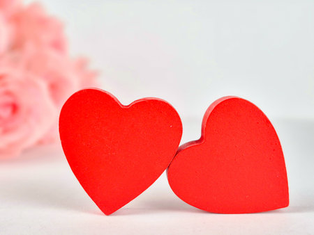 two red hearts with flowers in the background, valentines day card