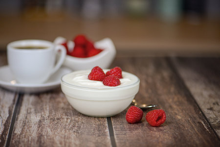 Greek yogurt with raspberries and coffee, healthy breakfastの写真素材