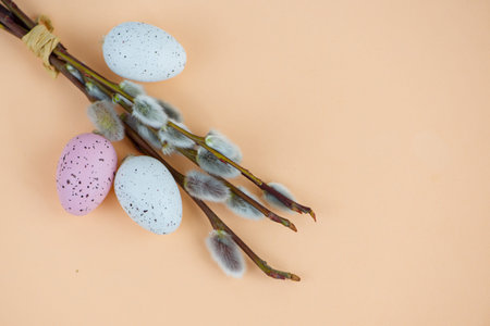 Eggs and willow branches on a beige background, Easter concept. High quality photo