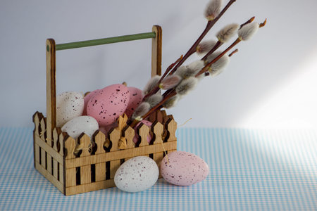 Easter eggs in a wooden basket on a white background. High quality photo