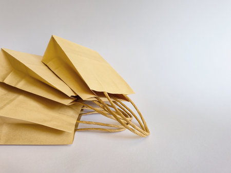 Elegant brown paper shopping bags perfect for retail and gifting, blending style with sustainability.の写真素材