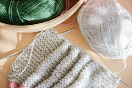 A peaceful scene showcasing various knitting supplies and crafted fabric, ideal for craft enthusiastsの写真素材