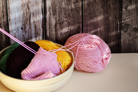 A beautifully cozy arrangement filled with vibrant, colorful yarns and knitting needles, perfect for crafting funの写真素材
