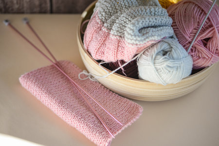 Enjoy the art of knitting with soft yarn and delicate needles in this cozy setup, perfect for creativityの写真素材