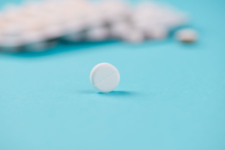 Pills and other medications close-up on blue background, health and medicine. High quality photo