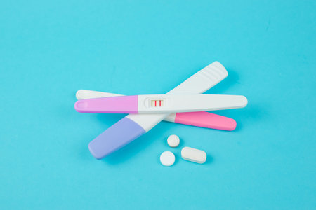 Long-awaited positive pregnancy test on a blue background. High quality photo