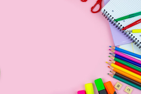 Discover a vibrant assortment of various stationery items designed for students and creatives against a pink backdropの写真素材